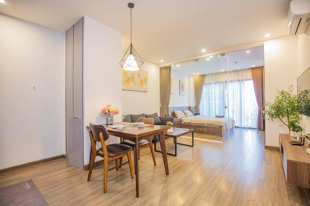 a living room with a dining room table and a couch at La Passion - Tay Ho Hanoi One Bedroom Apartment! in Hanoi