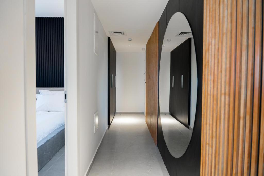 a hallway with four mirrors in a bedroom at Sea side "Iris" apartment - by Rently in Eilat