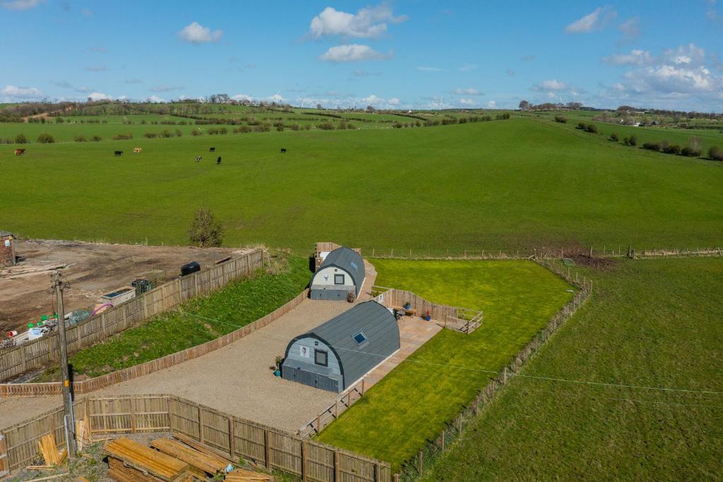 an aerial view of a barn in a field at The Stag Pod Farm Stay with Hot Tub Sleeps 2 Ayrshire Rural Retreats in Galston