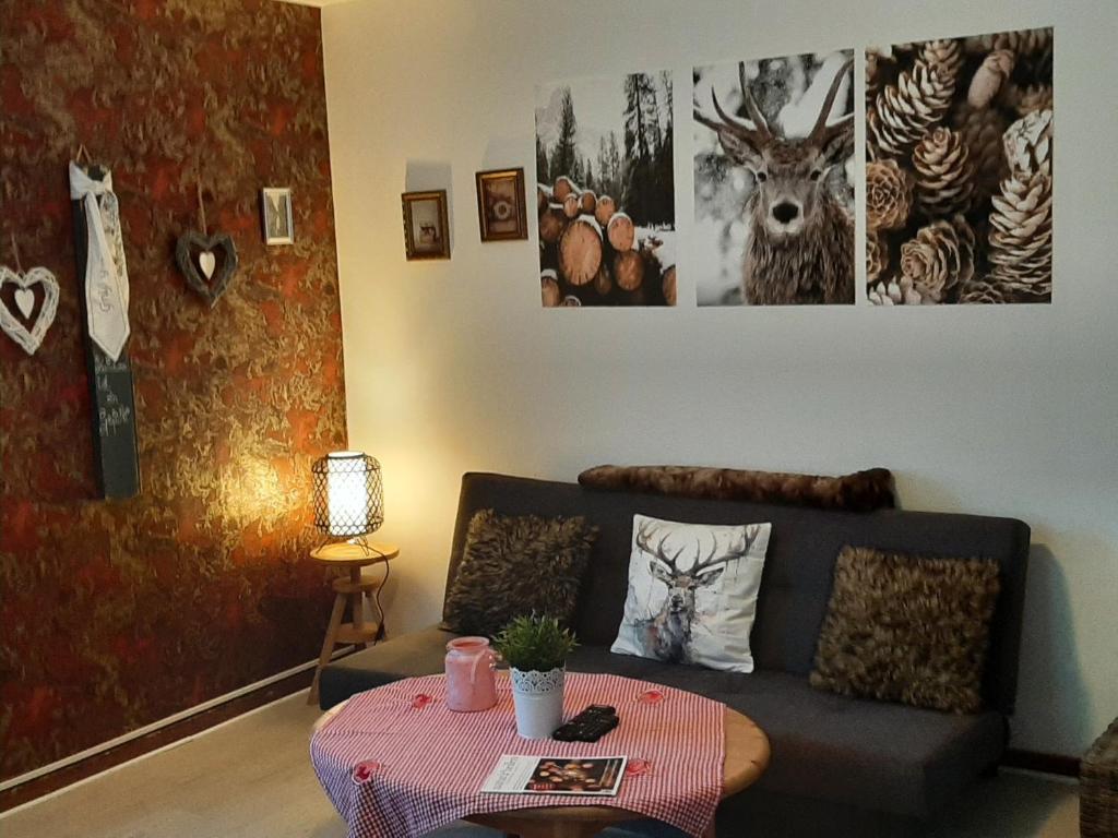 a living room with a couch and a table at FeWo Bergwiesen in Osterode