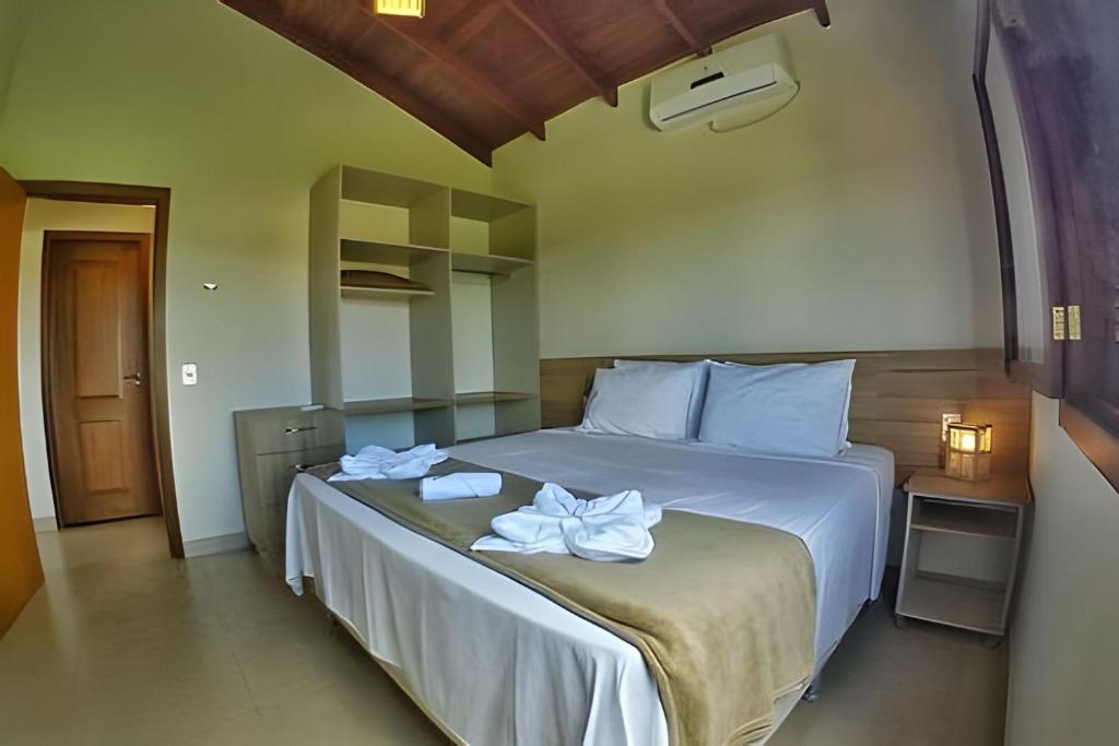 Postelja oz. postelje v sobi nastanitve Canto do Paraiso - Apartamento no Centro com ar condicionado