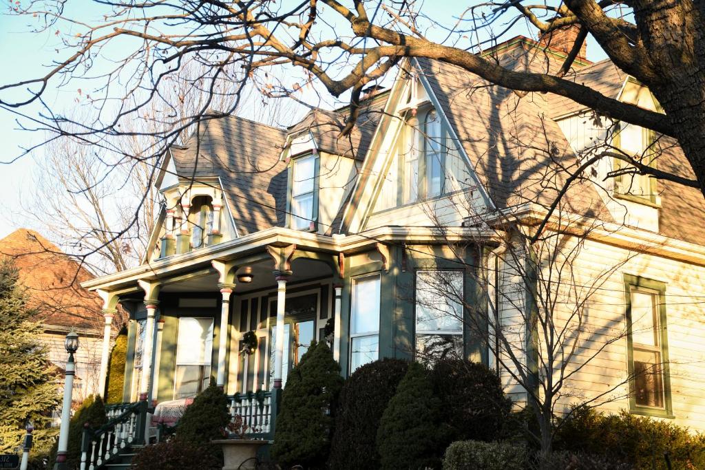 a large yellow house with a tree in front of it at MacFie House in Cape Girardeau