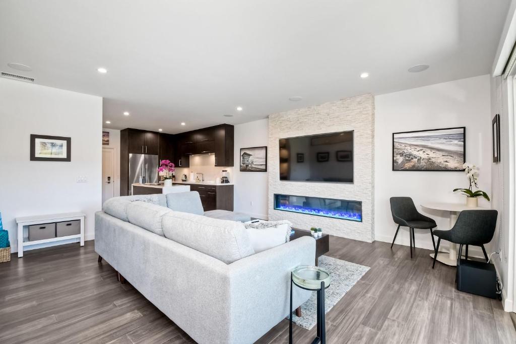 a living room with a white couch and a table at La Costa Luxury Condo - Fully Remodeled in Encinitas