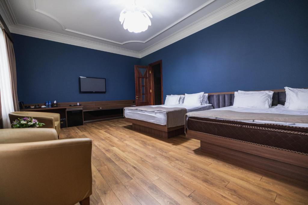 Postel nebo postele na pokoji v ubytování Golden Palace Hotel