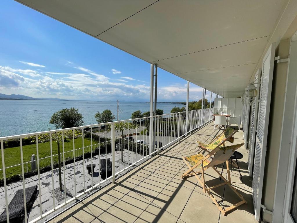 a balcony with a view of the water at SUNSET Apartment direkt am Bodensee mit Parkplatz in Lochau