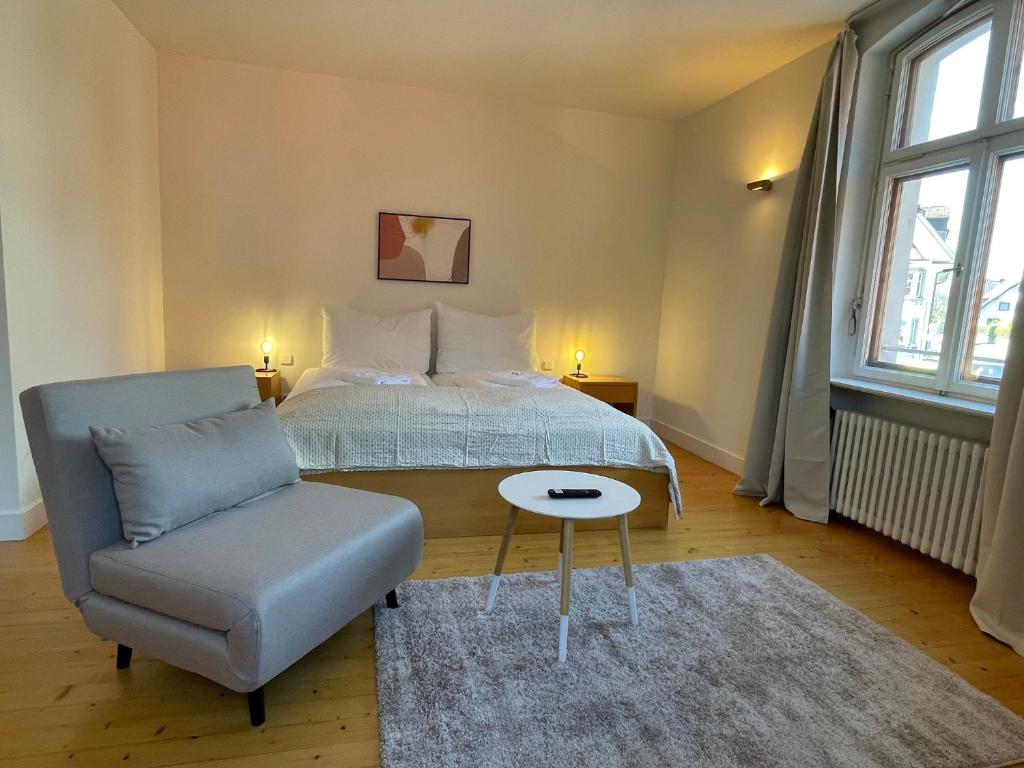 a bedroom with a bed and a chair at Studio im Zentrum von Lochau, #1 in Lochau