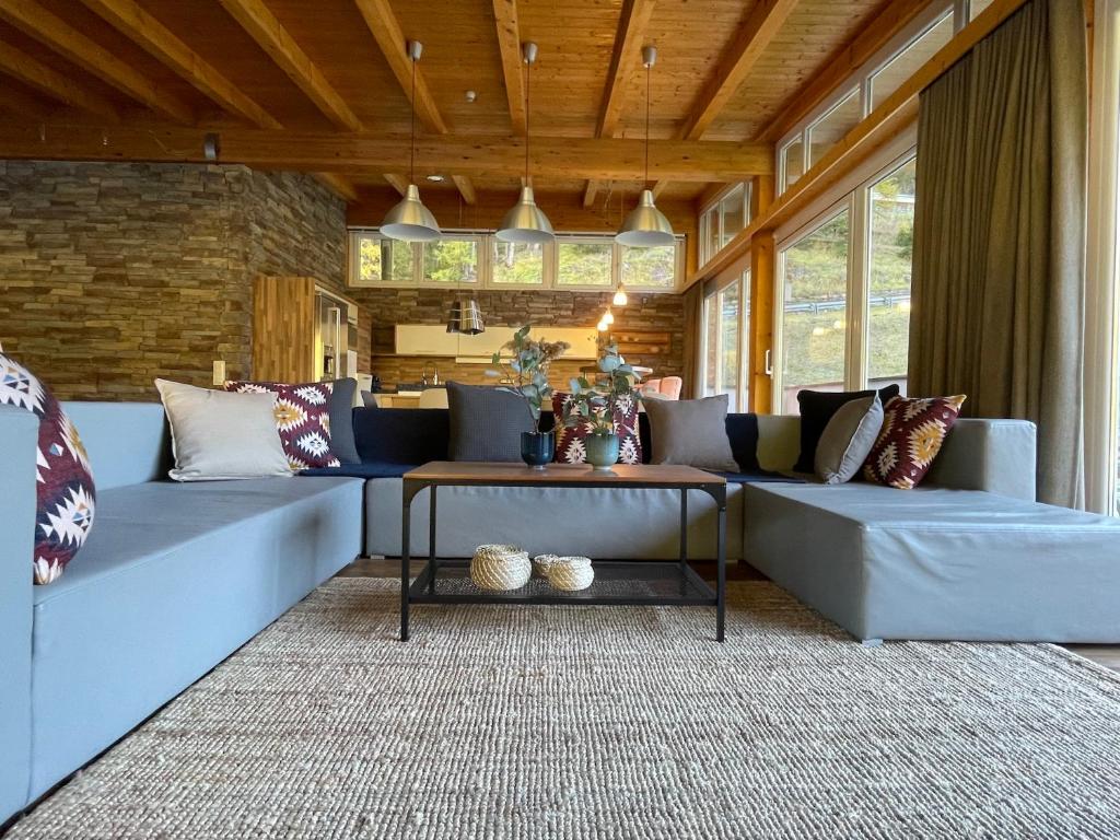 a living room with a couch and a table at International House Sölden Superior Suit Penthouse in Sölden