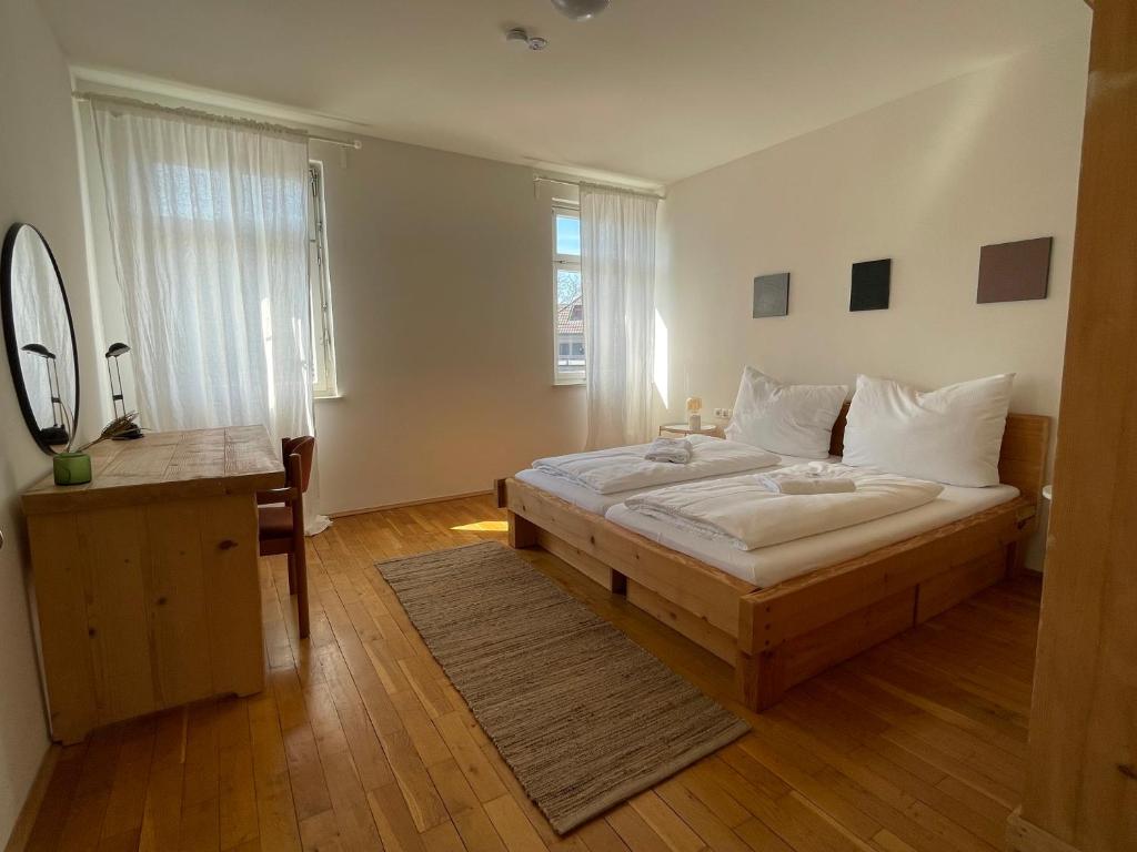 a bedroom with a bed and a desk and a mirror at Studio im Zentrum von Lochau, #5 in Lochau