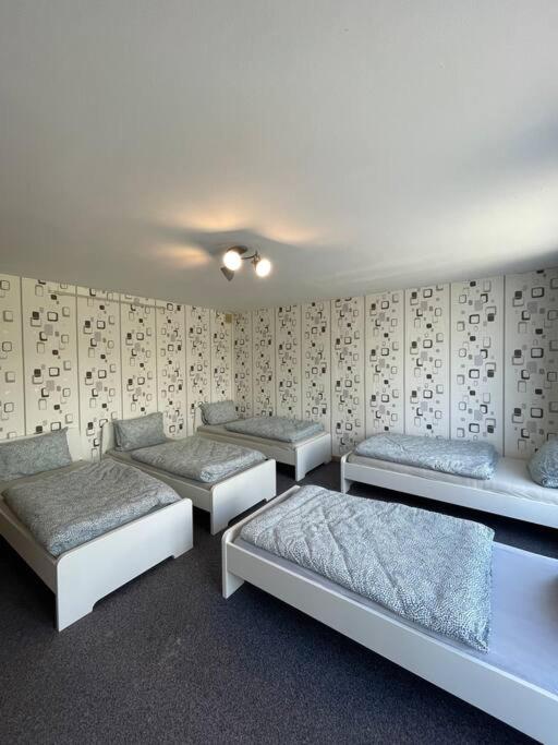 a room with four beds and a wall with at Wohnung nähe Düren Zentrum in Düren - Eifel