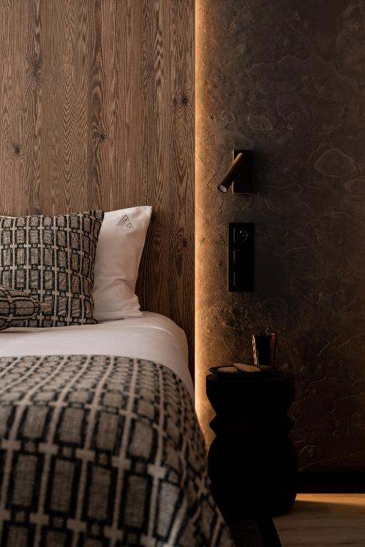 a bedroom with a bed with a black and white at Apartamenty Podhale in Zakopane