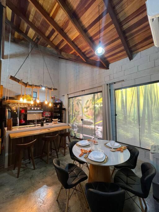a kitchen with a table and chairs in a room at recanto do sossego. in Sinop
