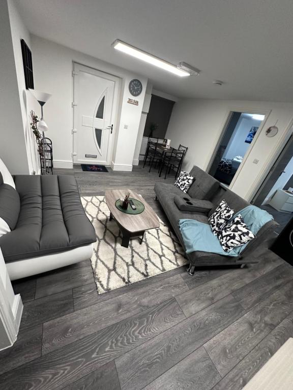 a living room with a couch and a table at Stunning 2-flat in Leicester! in Leicester