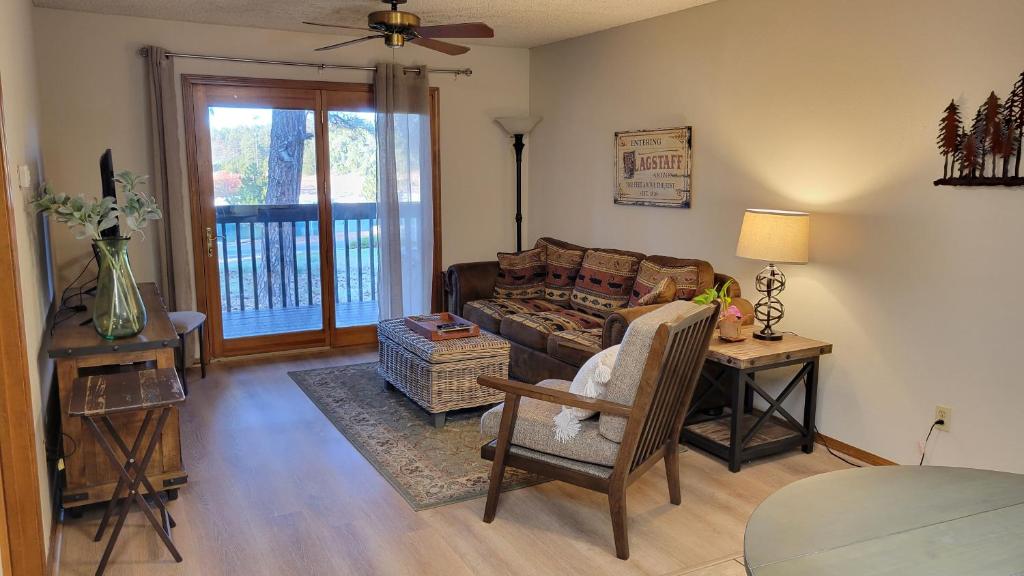 a living room with a couch and a table at Cozy Flagstaff Condo in Flagstaff
