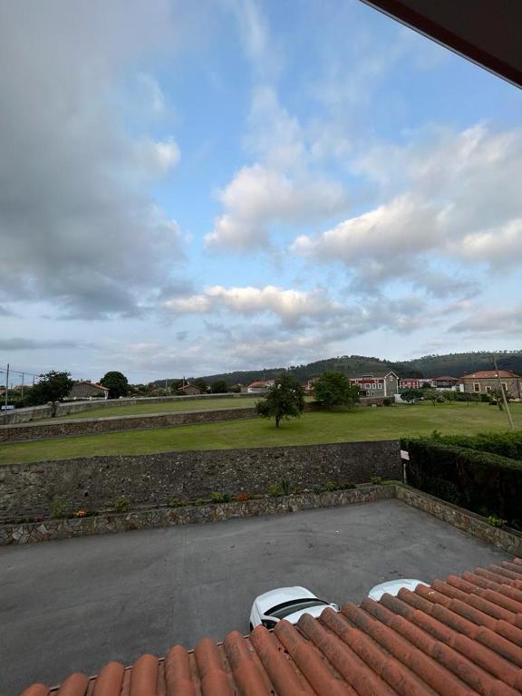 a view from the roof of a house with two chairs at Hotel Restaurante el Fornon in Novellana