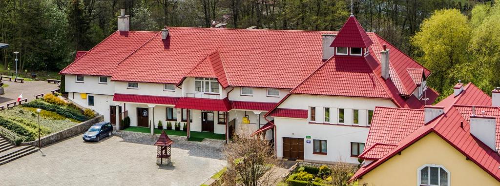a large house with a red roof at Magnificat in Niechobrz