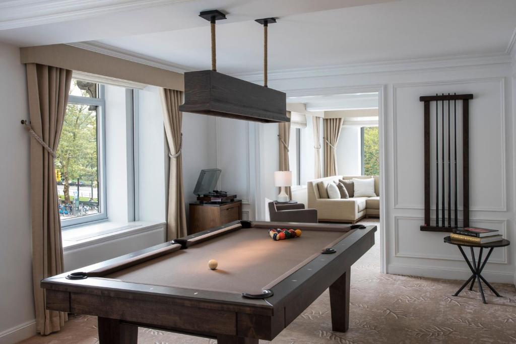 a living room with a pool table in it at The Ritz-Carlton New York, Central Park in New York
