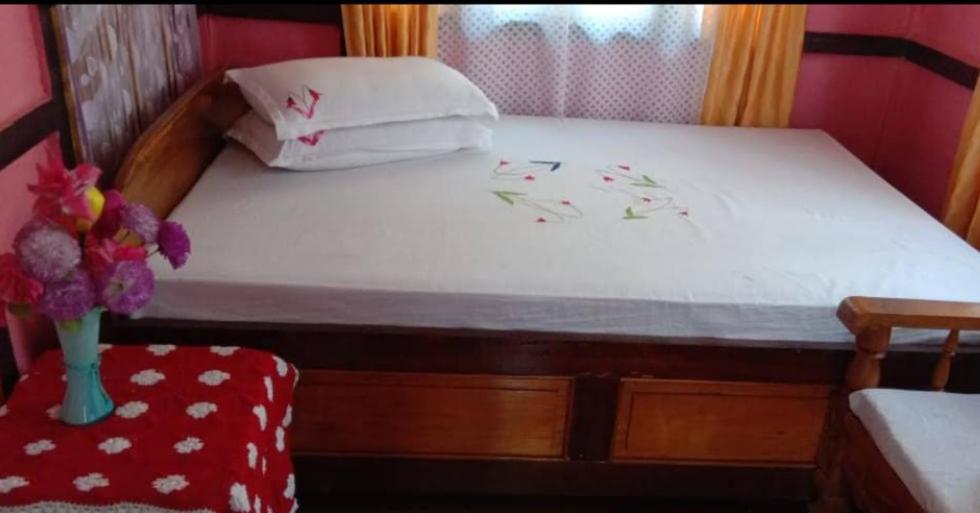 Postel nebo postele na pokoji v ubytování Green Magpie Homestay