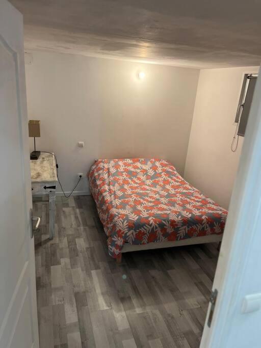 a small bedroom with a bed in the corner at Appartement Souplex, Cholet in Cholet