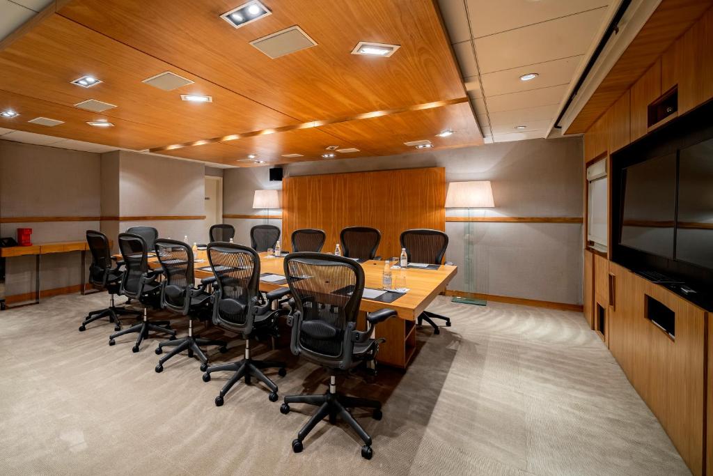 a conference room with a long table and chairs at Hotel Emiliano in Sao Paulo