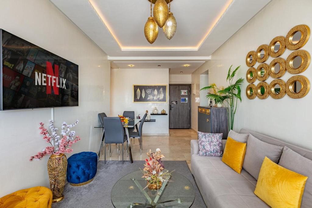 a living room with a couch and a table at Cozy 2-bedroom apartment in Gueliz, Marrakech in Marrakesh