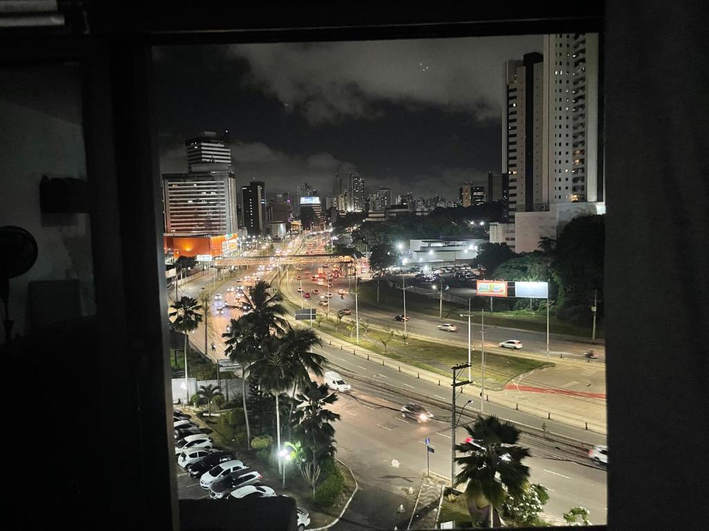 a view from a window of a city at night at Flat com Ar Condicionado Ana Regis AP 307, Salvador in Salvador