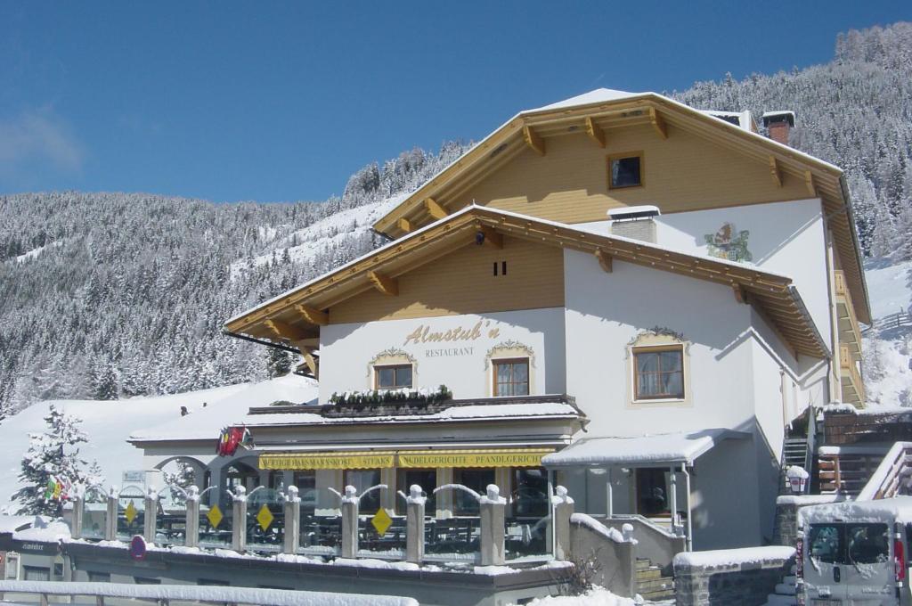 ein großes Gebäude mit Schnee an der Seite in der Unterkunft Hotel Berghof in Innerkrems