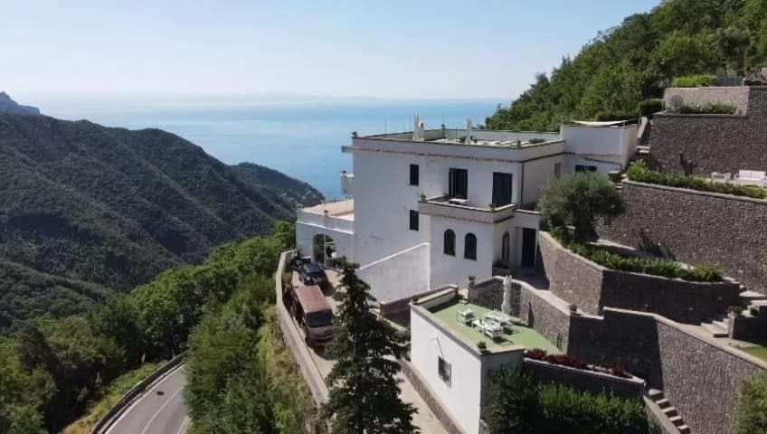 a large white building on top of a mountain at Adagio Ravello in Ravello