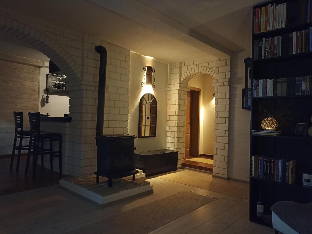 a living room with a fireplace in a brick wall at Lux Apartment Sunset in Virpazar