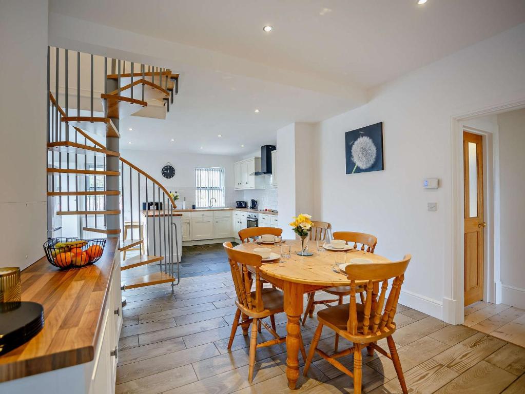a kitchen and dining room with a wooden table and chairs at 3 bed in Hamsterley 81503 in Evenwood