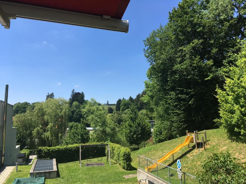 a playground with a slide on a hill with trees at sonniges Appartement in Mariatrost in Graz