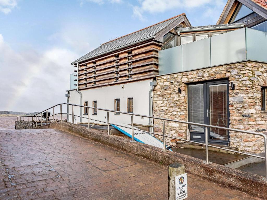 a stone house with a balcony on the side of it at 2 Bed in Lympstone 80586 in Lympstone