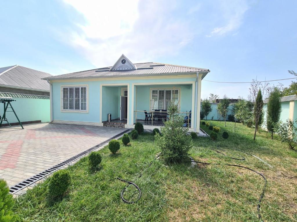 a small blue house with a lawn in front of it at Small Reyis villa 1 in Gabala