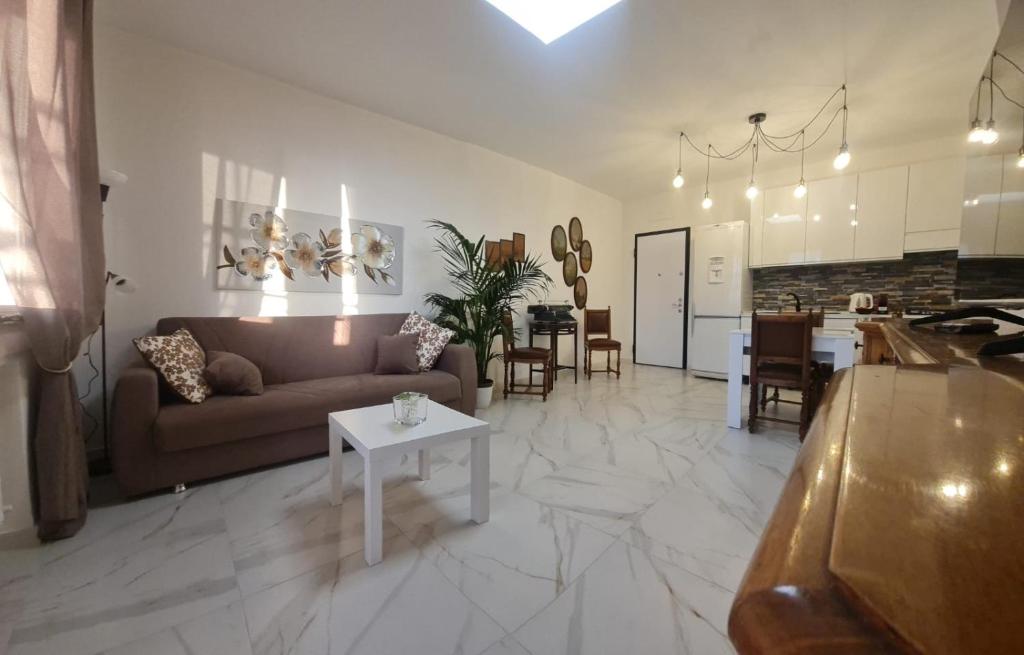 a large living room with a couch and a table at ATTICO GENOVA con POSTO AUTO in Genova