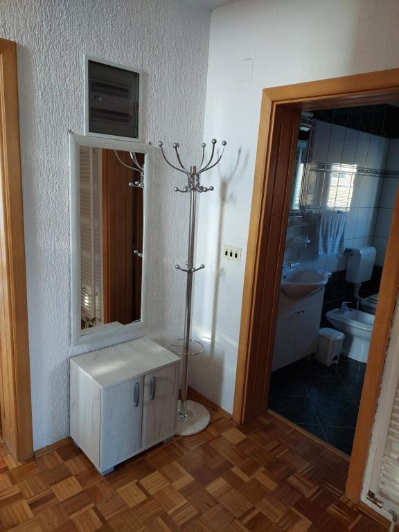 a bathroom with a sink and a mirror and a toilet at Kuća Vesna in Kupres