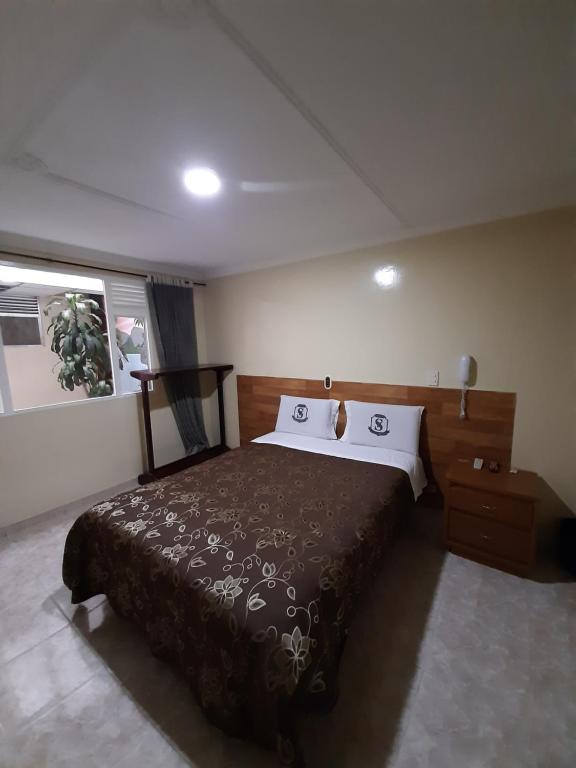 Postel nebo postele na pokoji v ubytování Hotel Nuevo Siboney