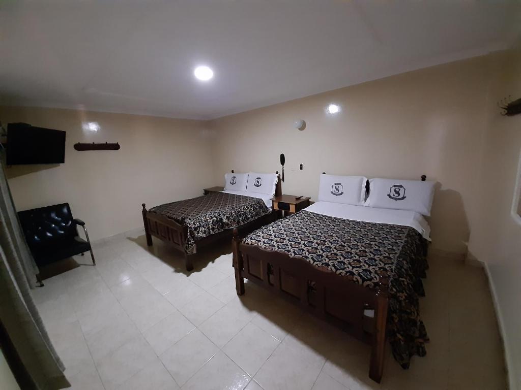 Postel nebo postele na pokoji v ubytování Hotel Nuevo Siboney