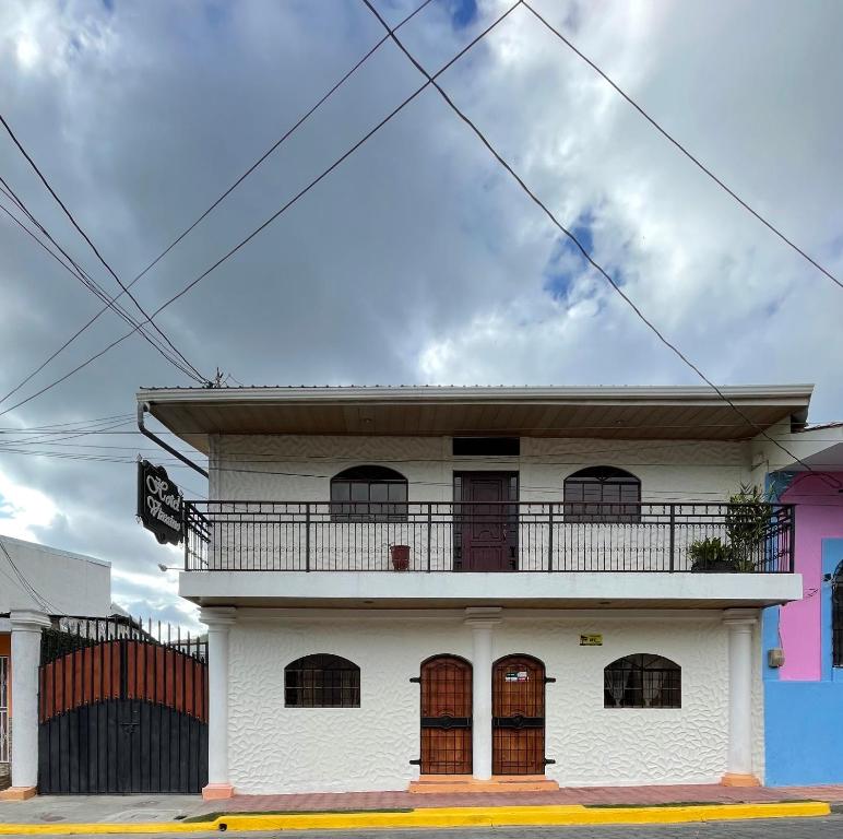 a white building with a balcony on top of it at Hotel Vizcaino in Matagalpa