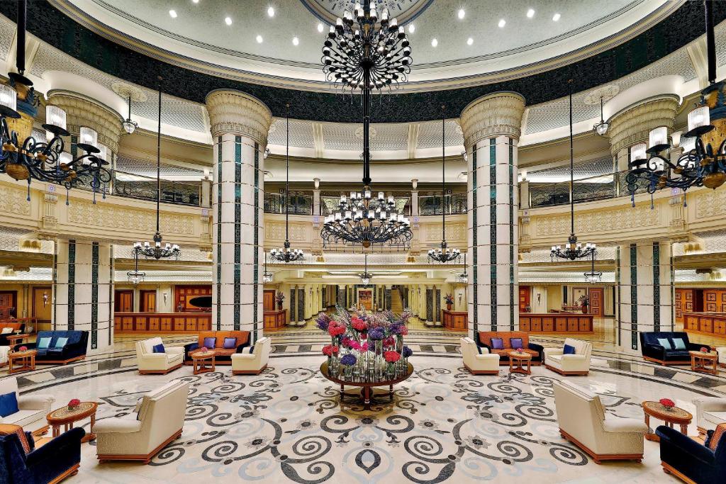a lobby of a hotel with chairs and a large building at The Ritz-Carlton Jeddah in Jeddah