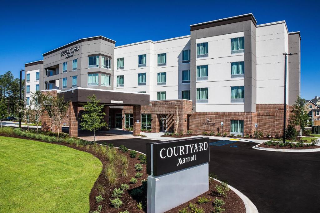 a hotel with a sign in front of a building at Courtyard by Marriott Columbia Cayce in Cayce