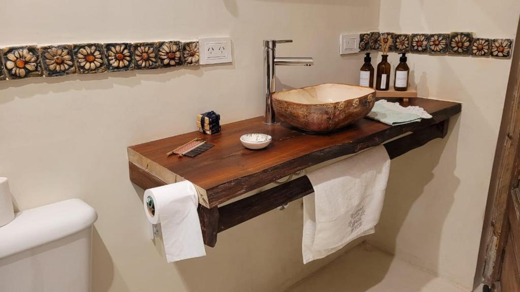 a bathroom with a wooden counter with a sink at Casona Islas Blancas in Camarones