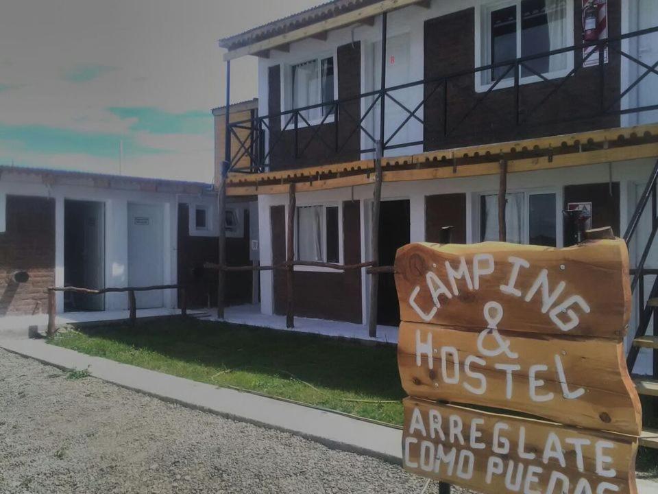 a sign in front of a building at Arreglate como puedas in Gobernador Gregores