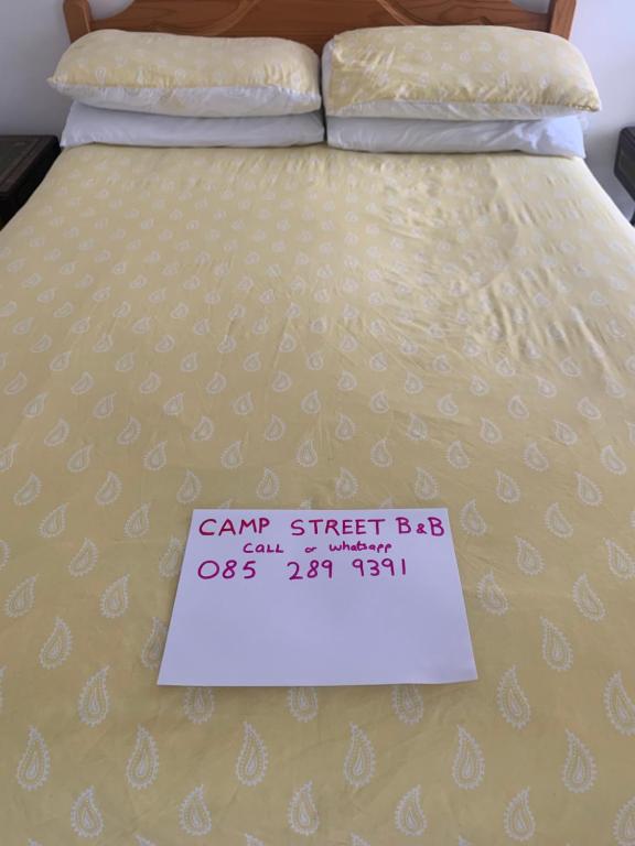 a bed with a canaan street bed sign on it at Room 1 Camp Street B&B in Oughterard
