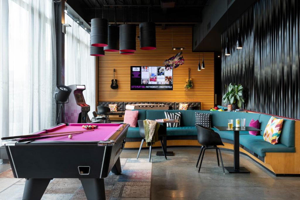 a billiard room with a pool table and a tv at Moxy Aberdeen Airport in Dyce