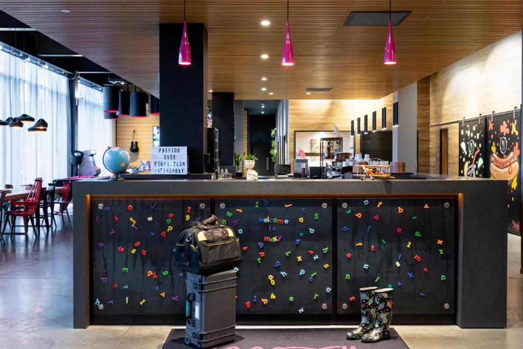 a rock wall in a restaurant with a climbing wall at Moxy Aberdeen Airport in Dyce