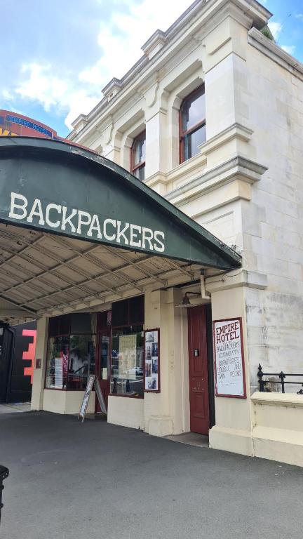 a building with a back packers sign on it at Empire Hotel Backpackers in Oamaru