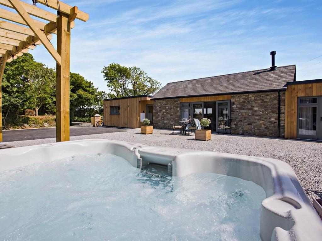 a hot tub in the backyard of a house at 3 Bed in Hartland 91183 in Hartland