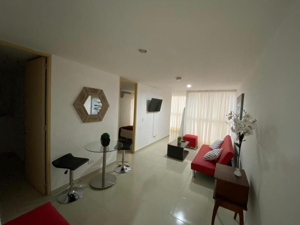 a living room with a red couch and a red chair at Amoblados Rugeles 2 habitaciones muy central ! in Bucaramanga