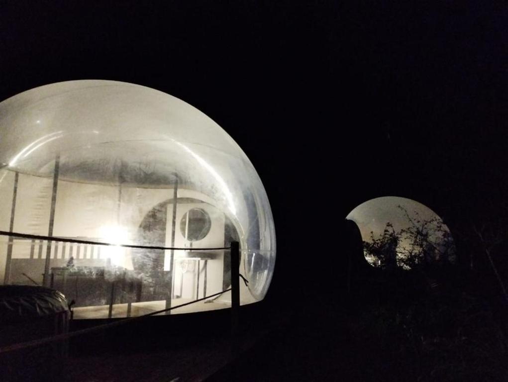 a glass dome with a house in it at night at Finca Esferas in La Guancha