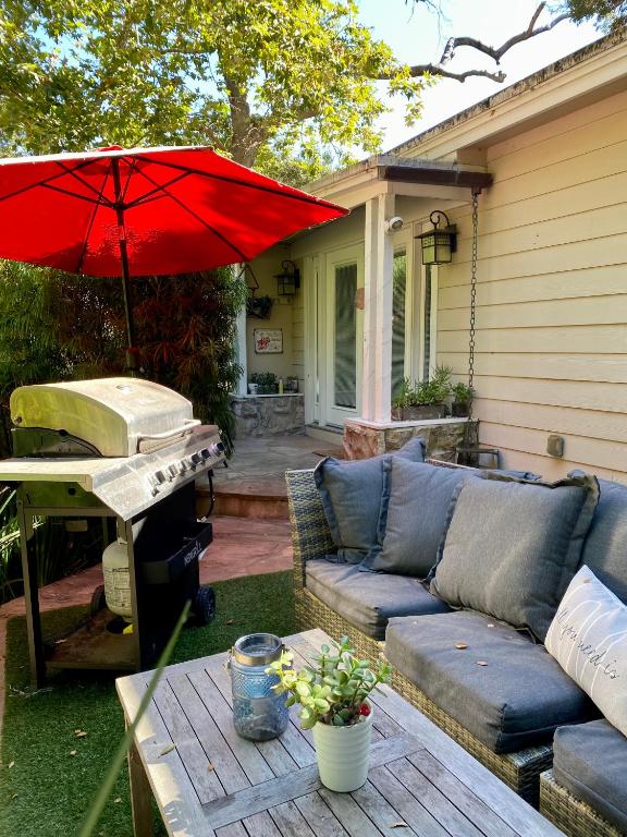 a patio with a couch and a table with an umbrella at Malibu Ranch Guest House Hideway in Malibu