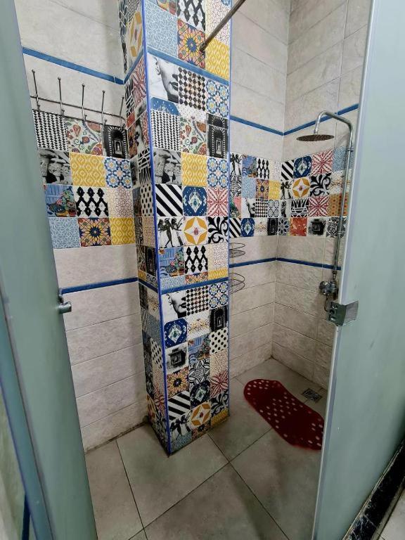 a bathroom with a shower with mosaic tiles at Cairo Hub in Cairo